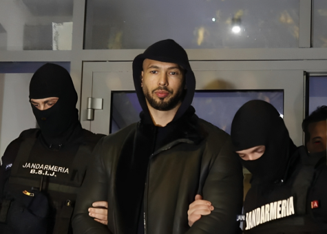  Andrew Tate escorted out by policemen due to his warrant of arrest.