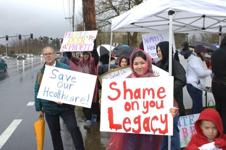 A group of people protesting Legacy’s closure of Mt. Hood’s family birth center.