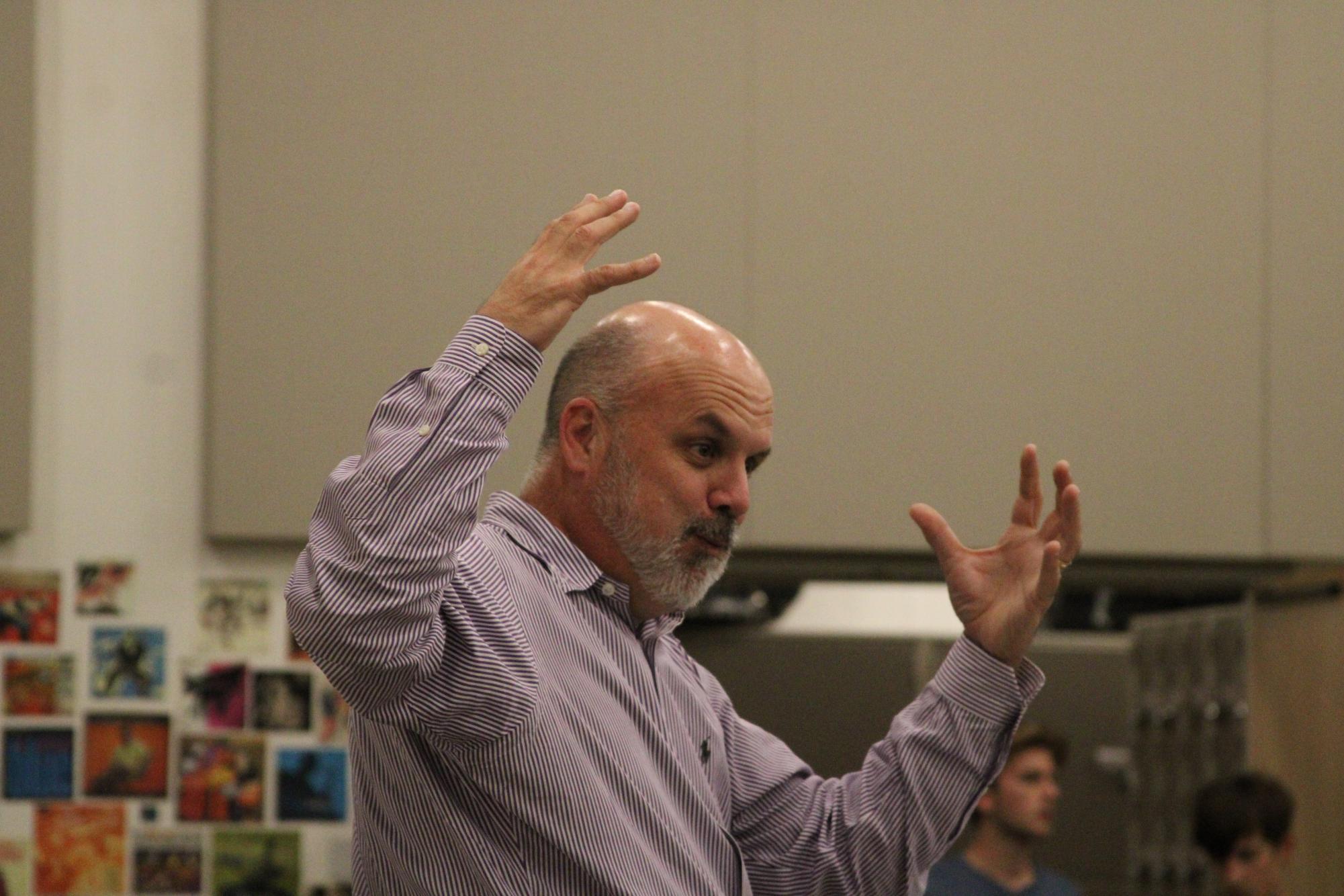 Mr. Nicholas passionately directs his band students during a lively piece for their upcoming concert.