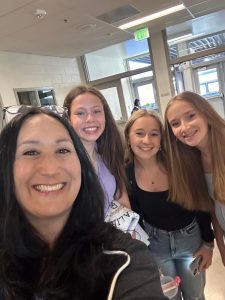 Fay posing with a couple of students on the first day of school.