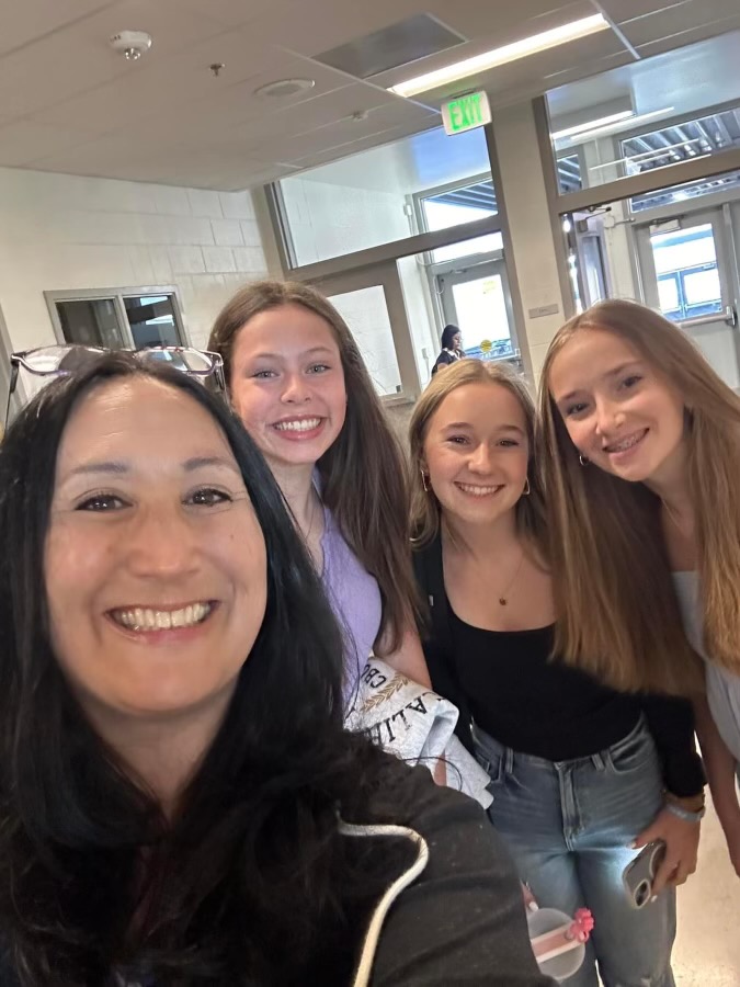 Fay posing with a couple of students on the first day of school.