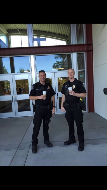 Former SROs, Officer Rasmussen and Officer Sweazey standing outside of  Gordon Russell Middle School