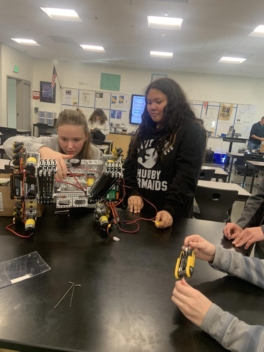 Two robotics members working on the t-shirt cannon as the 2024/2025 school year robotics project.