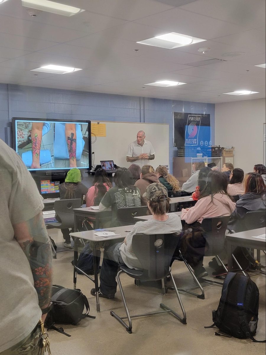 Tattoo Artist, Ben Berry giving a presentation on his path to being a tattoo artist, instructor, and business owner.