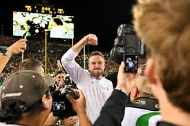 Dan Lanning celebrating in Autzen Stadium after the Ducks win a nailbiter against number 2 Ohio State