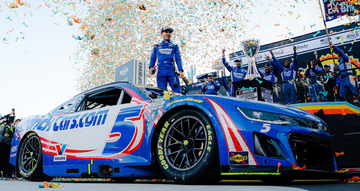 Kyle Larson celebrating his second NASCAR Cup Championship with his Hendrick Motor Sports crew in front of his iconic 5 car 