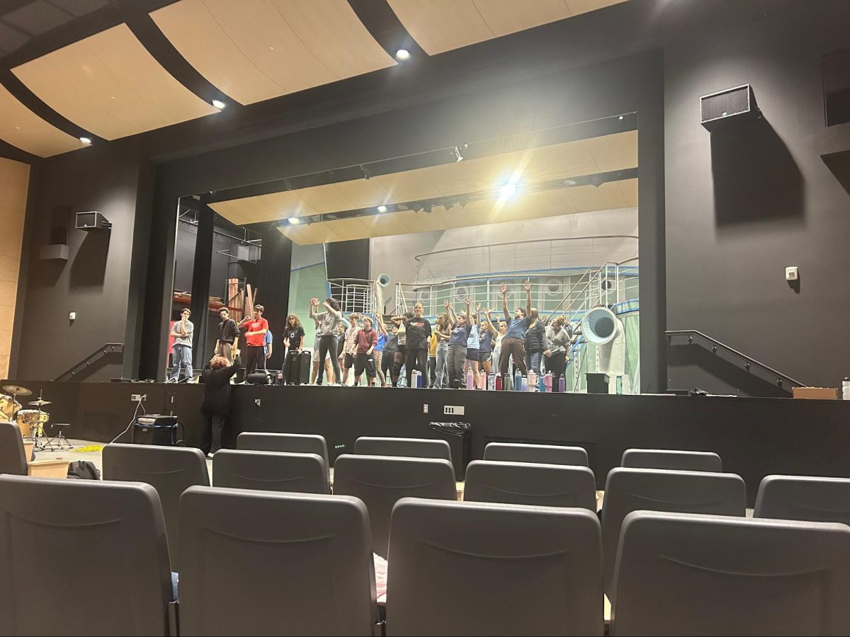 The entire ensemble rehearses a group number