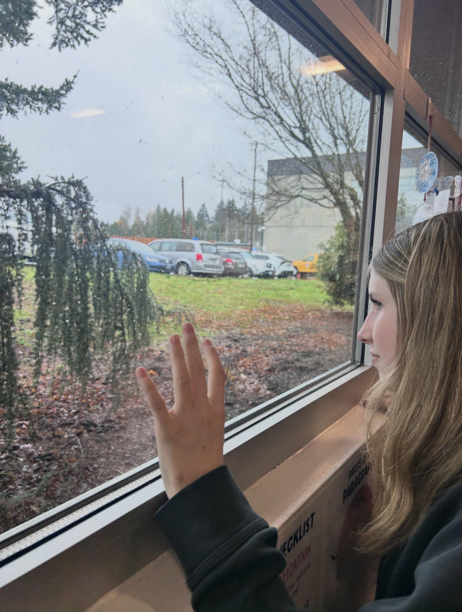Kourtney Langford, 15, looking out the window of Sam Barlow High School, reaching for an escape.