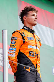 2025 World Drivers’ Championship winner, Lando Norris, standing on the podium after winning the Dutch Grand Prix