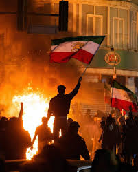Iranian protestors wave the pre-1979 Iranian flag at the anti regime demonstration
