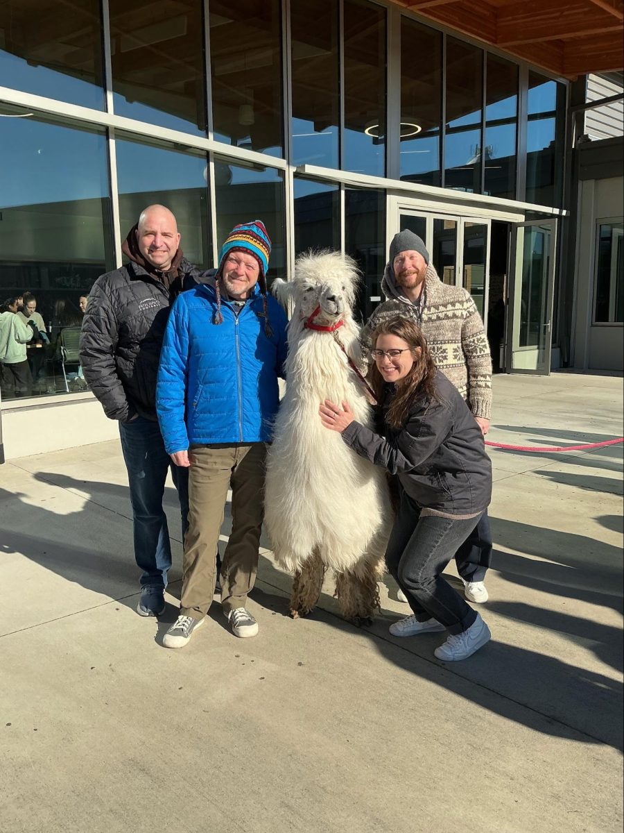 English teachers, Mr. Arnold, Mr. Nelson, Mr. Stewart, and Mrs. Schearer pose with Caesar after a long wait during lunch.